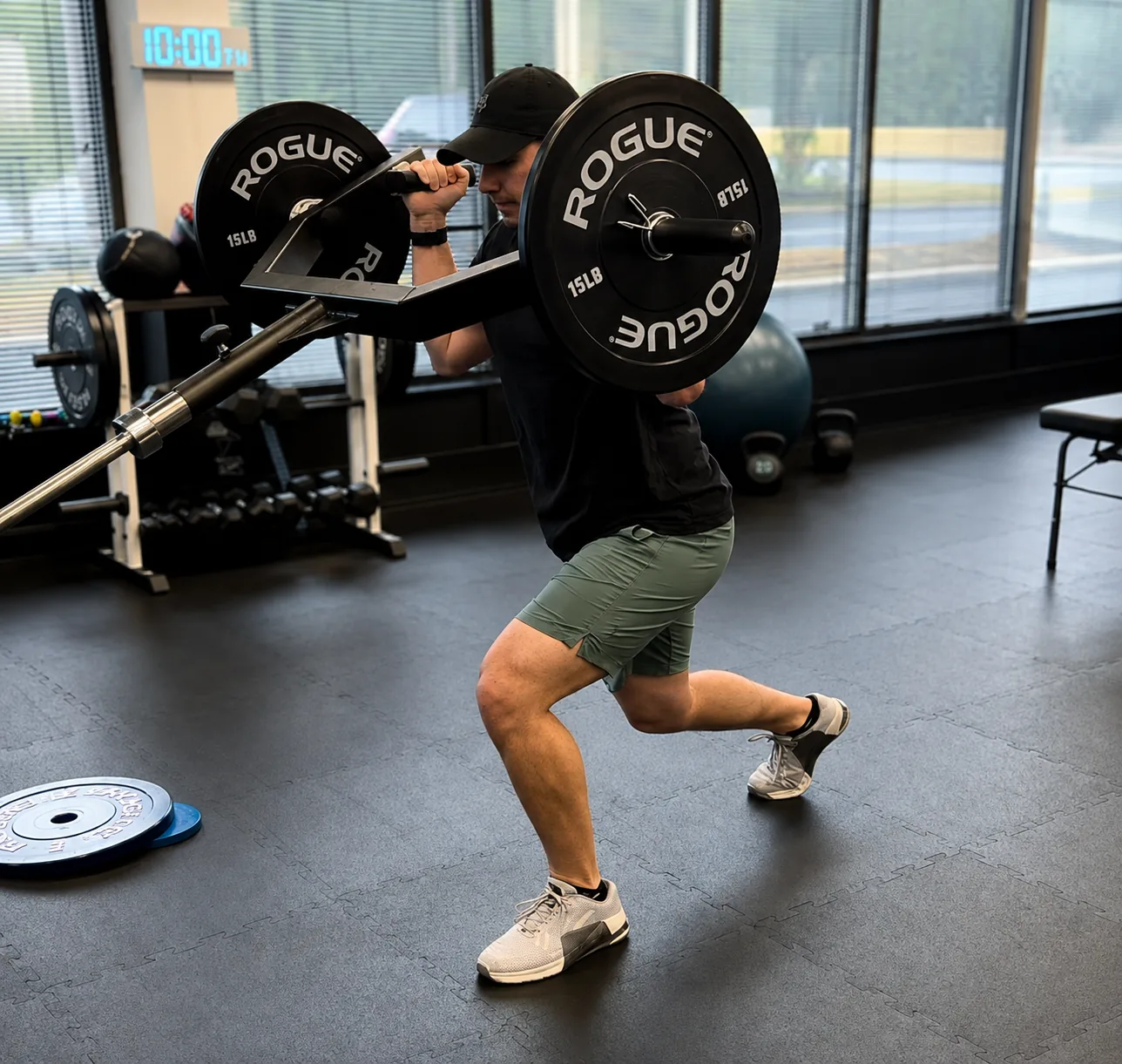 Athlete performing a clean bar attachment lift during sports performance training