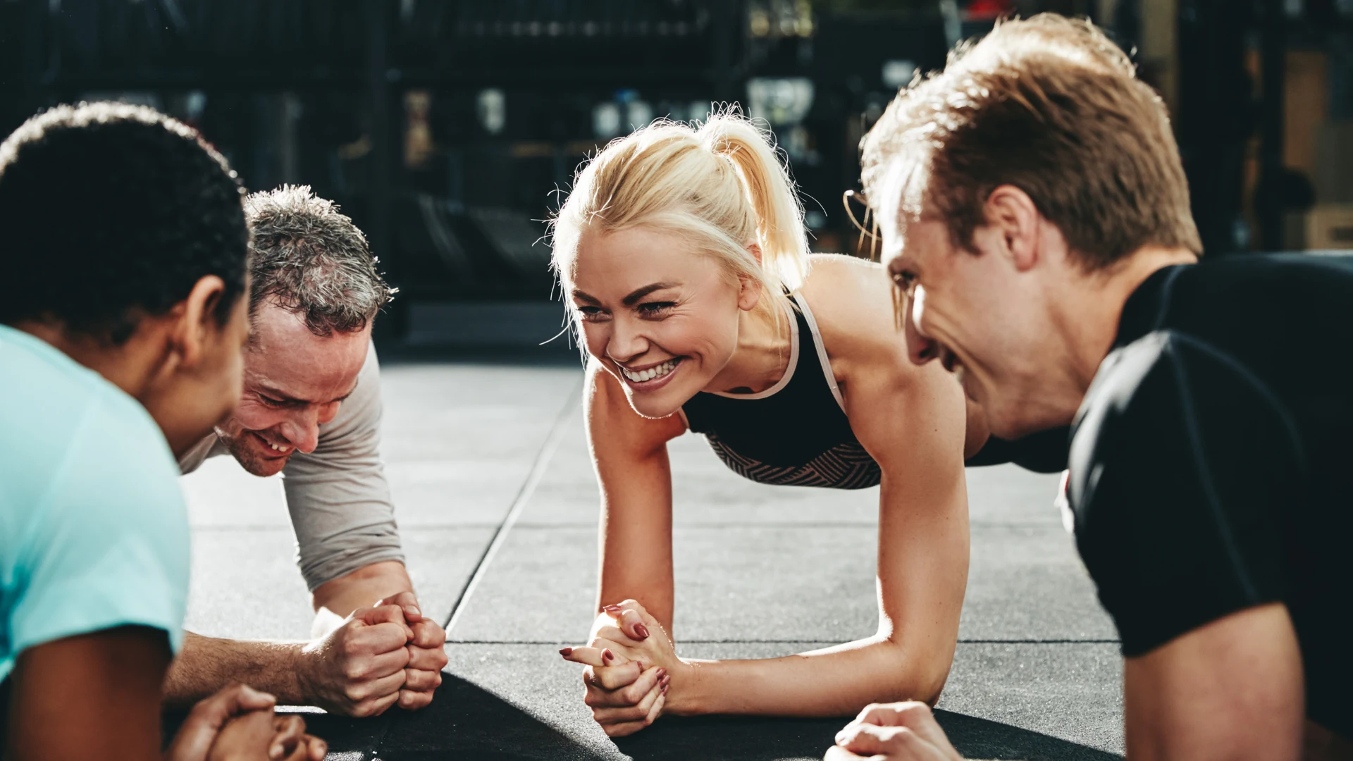 Group holding planks during a strength workout