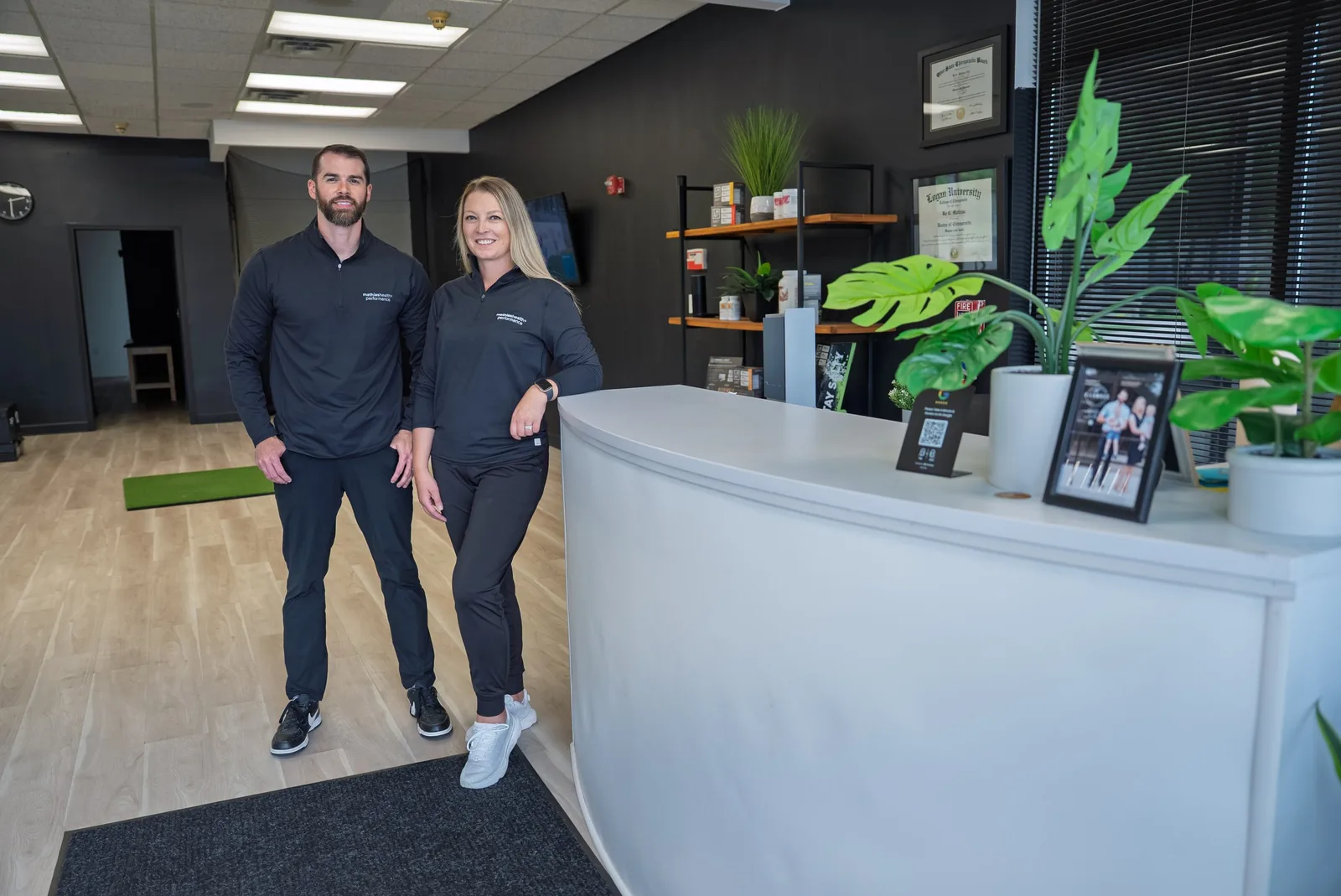 Dr. Mathias and Liza at the Mathias Health and Performance front desk